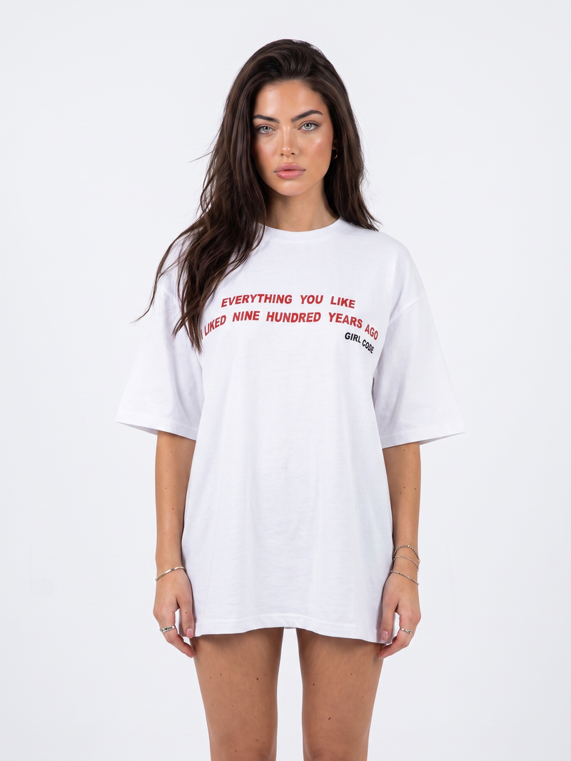 Model wearing Girl Code white chain back slogan t-shirt, front view showing red slogan print