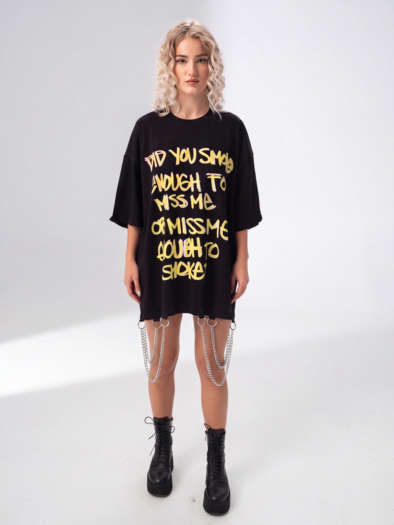 Model wearing Girl Code black chain hem slogan t-shirt, front view showing handmade chain detail at hem