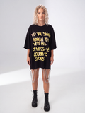Model wearing Girl Code black chain hem slogan t-shirt, front view showing handmade chain detail at hem