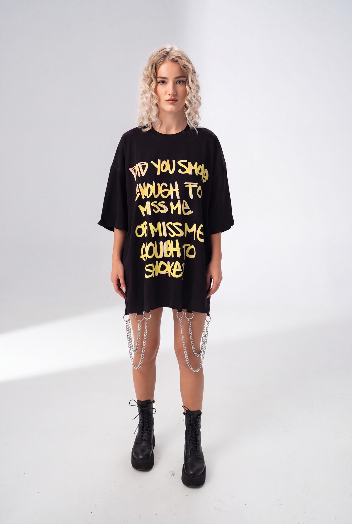 Model wearing Girl Code black chain hem slogan t-shirt, front view showing handmade chain detail at hem