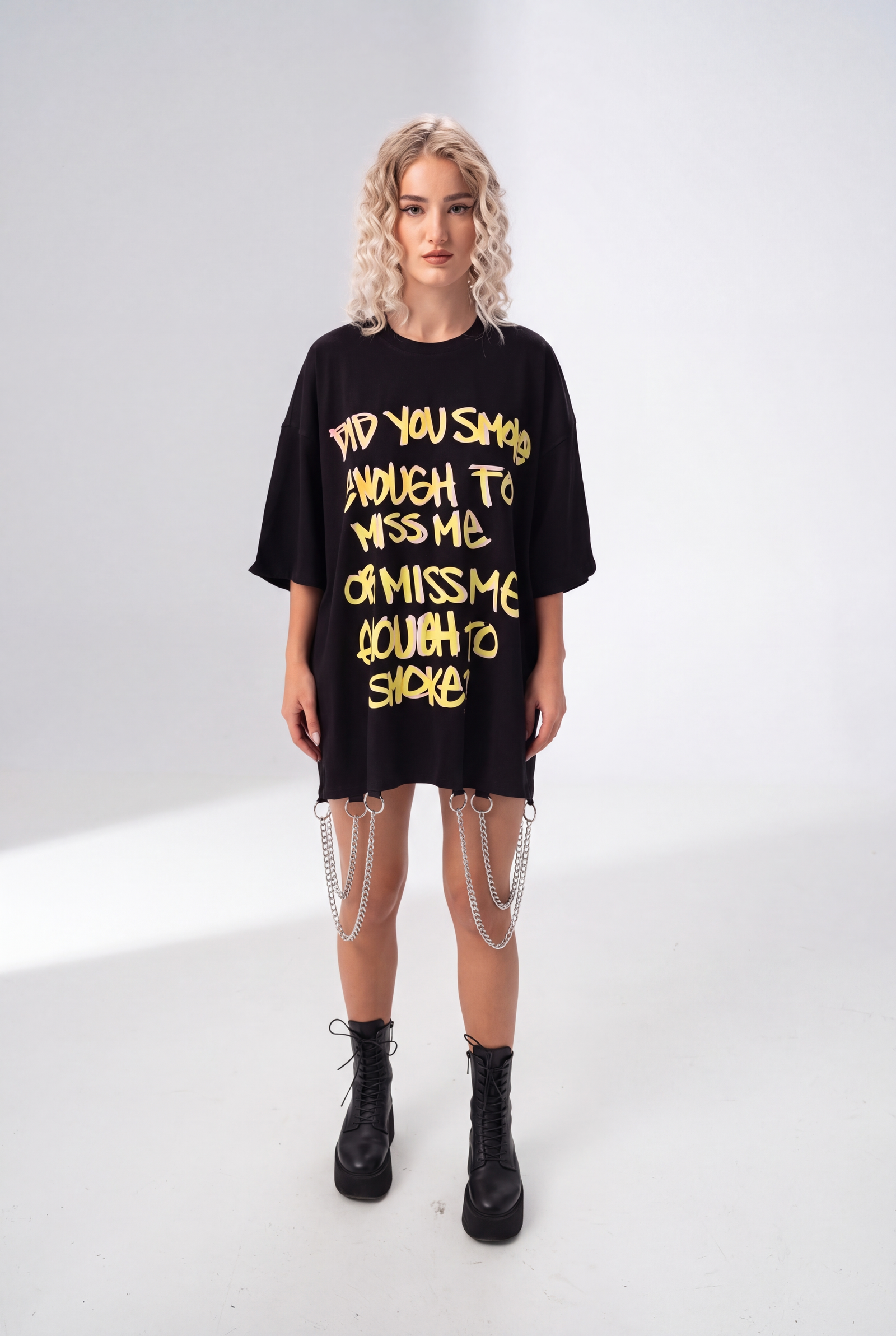 Model wearing Girl Code black chain hem slogan t-shirt, front view showing handmade chain detail at hem
