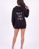 Back view of the Girl Code black hoodie showing NOT 'UR TOY spelled in crystal rhinestones across the back