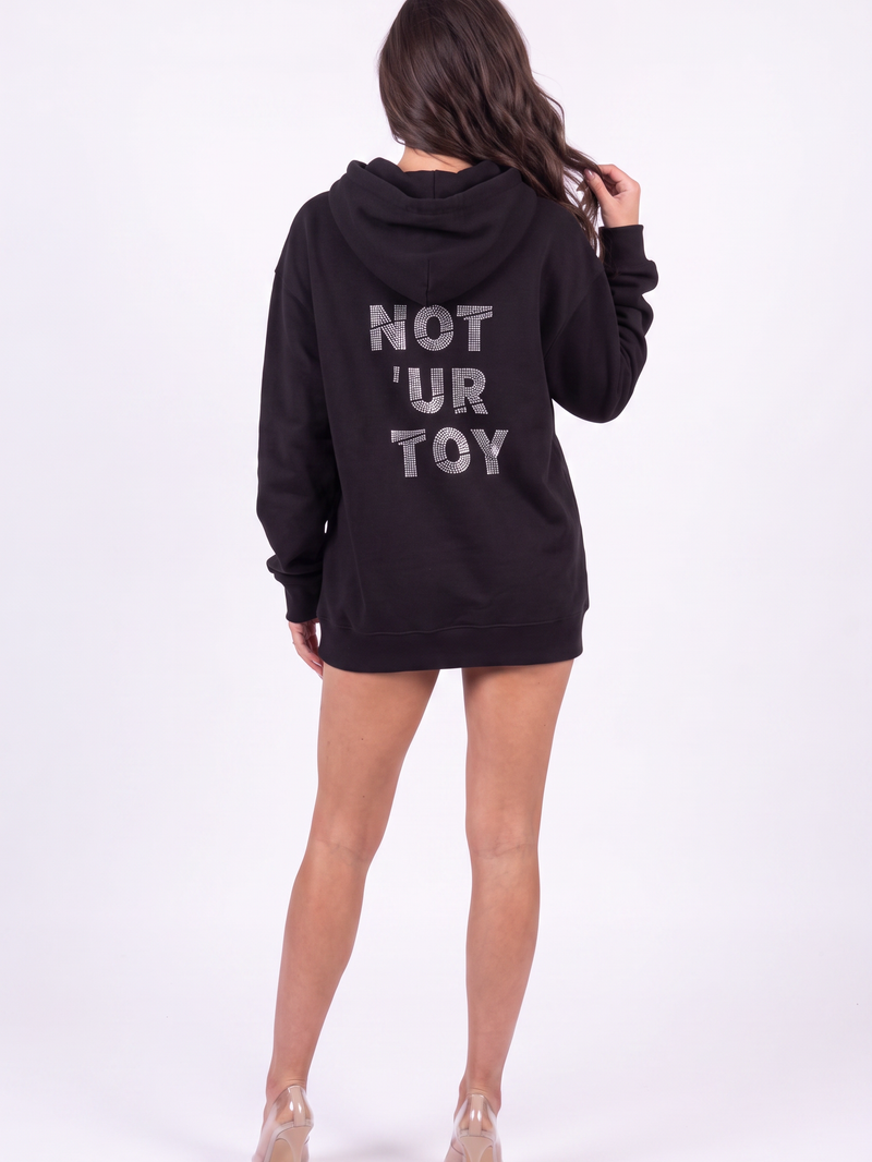 Back view of the Girl Code black hoodie showing NOT 'UR TOY spelled in crystal rhinestones across the back