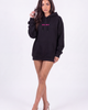 Model wearing Girl Code black oversized hoodie with GIRL CODE pink print on the chest, front view