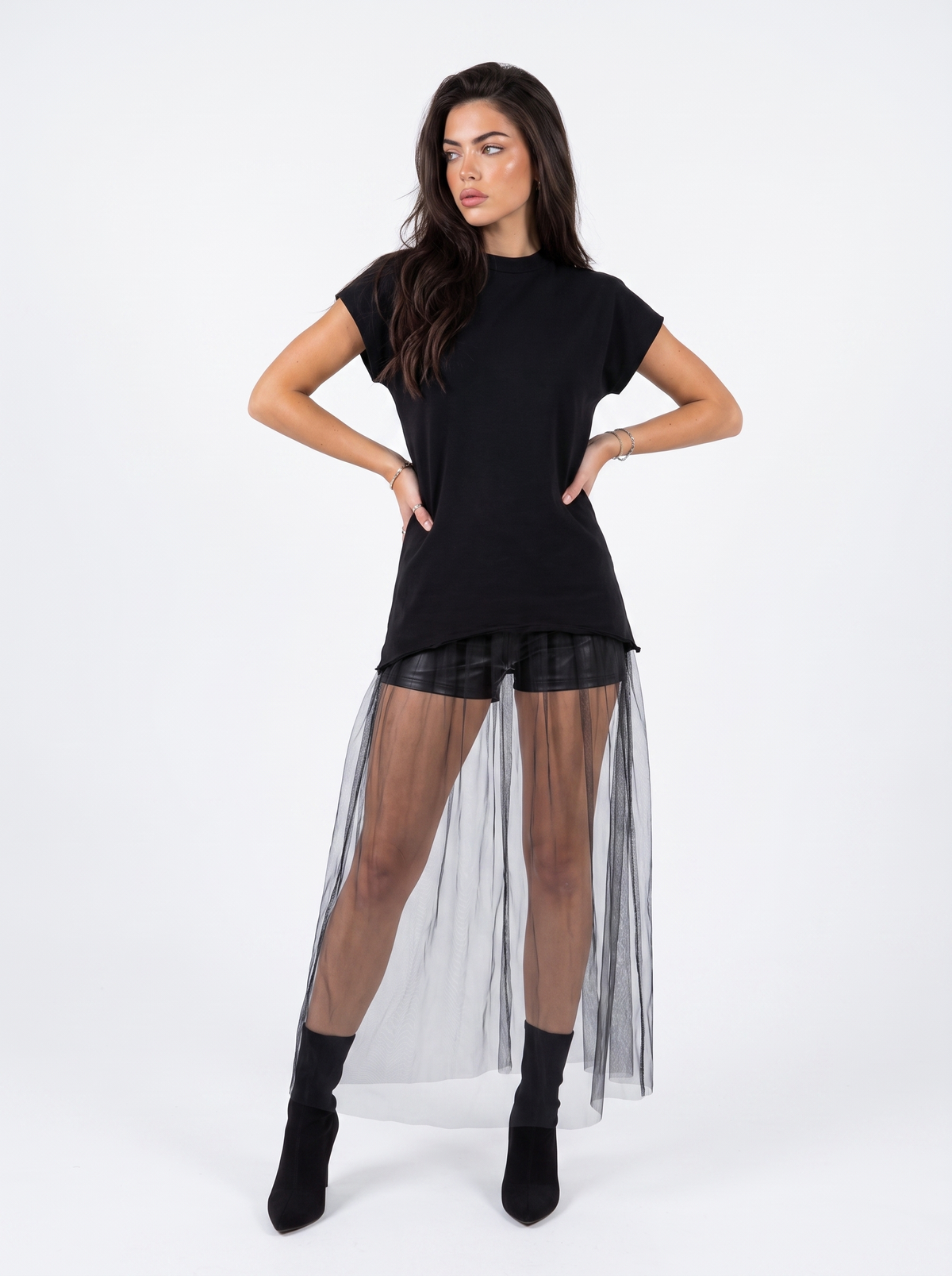 Model wearing Girl Code black heart cutout t-shirt dress with sheer tulle skirt, side view