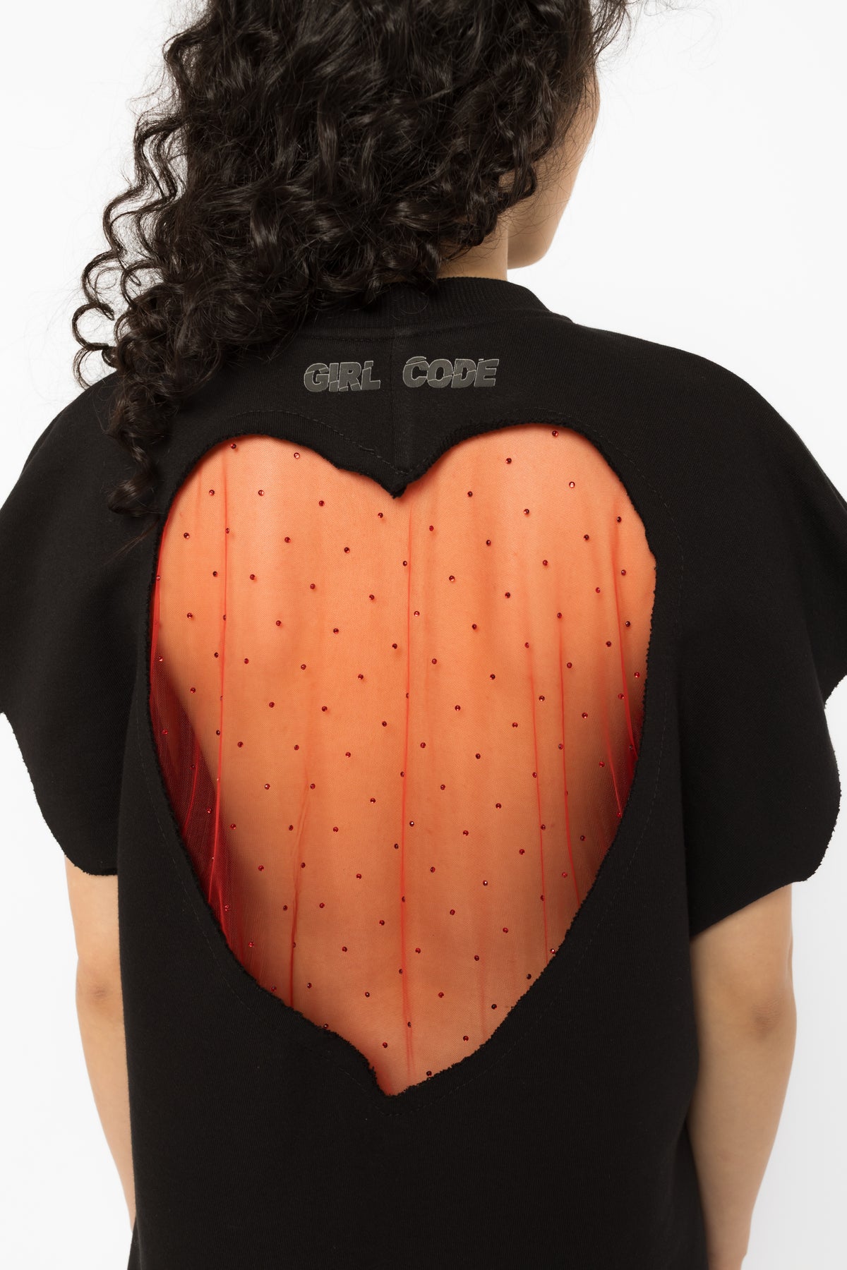 Red crystal tulle heart cutout across the back of the black oversized t-shirt