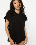 Black oversized t-shirt with raw cut edges worn with knee high boots