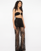 Model wearing Girl Code black lace-up palazzo pants, front view showing full wide leg silhouette