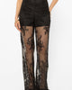 Lace-up detailing running down the leg of the black palazzo pants
