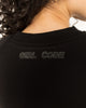 Close up of the tonal Girl Code logo printed at the back neck of the black crop top