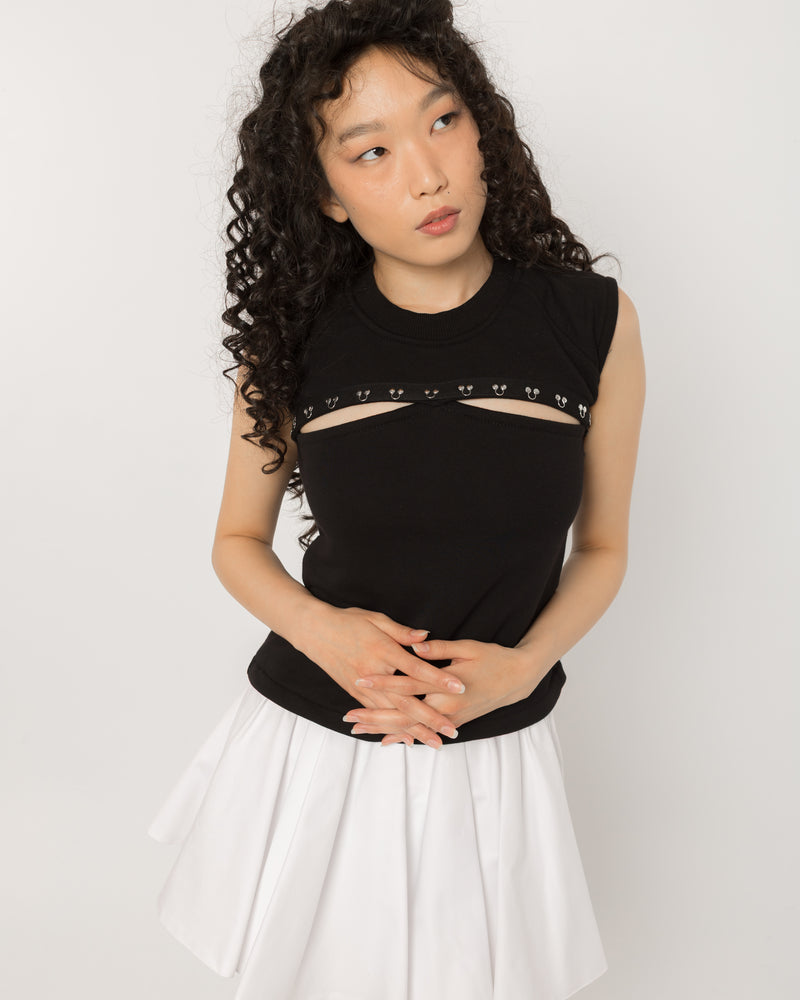 Model wearing Girl Code black pierced cutout sleeveless top, front view