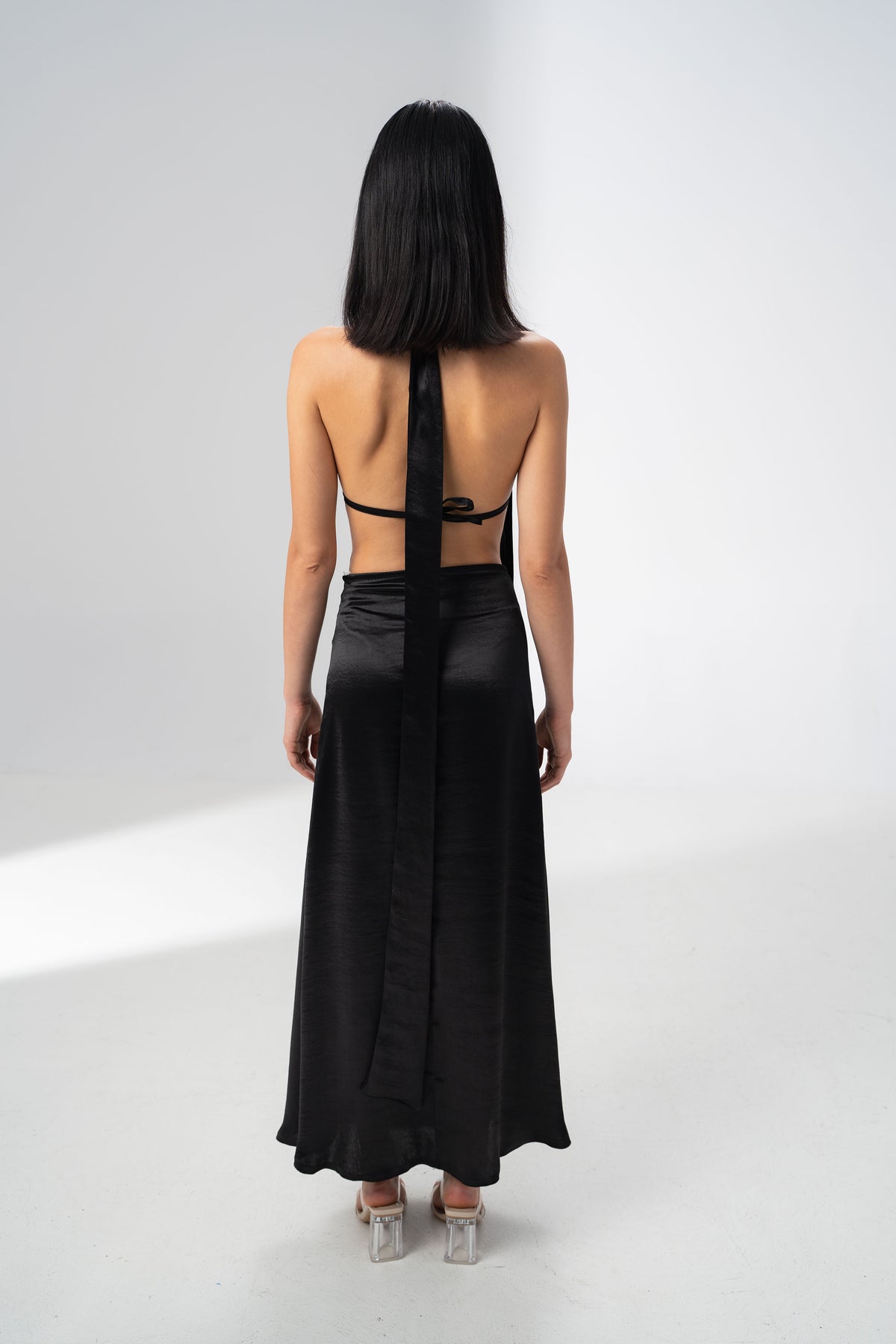 Draped bust and halter neck tie of the Girl Code black satin two piece set