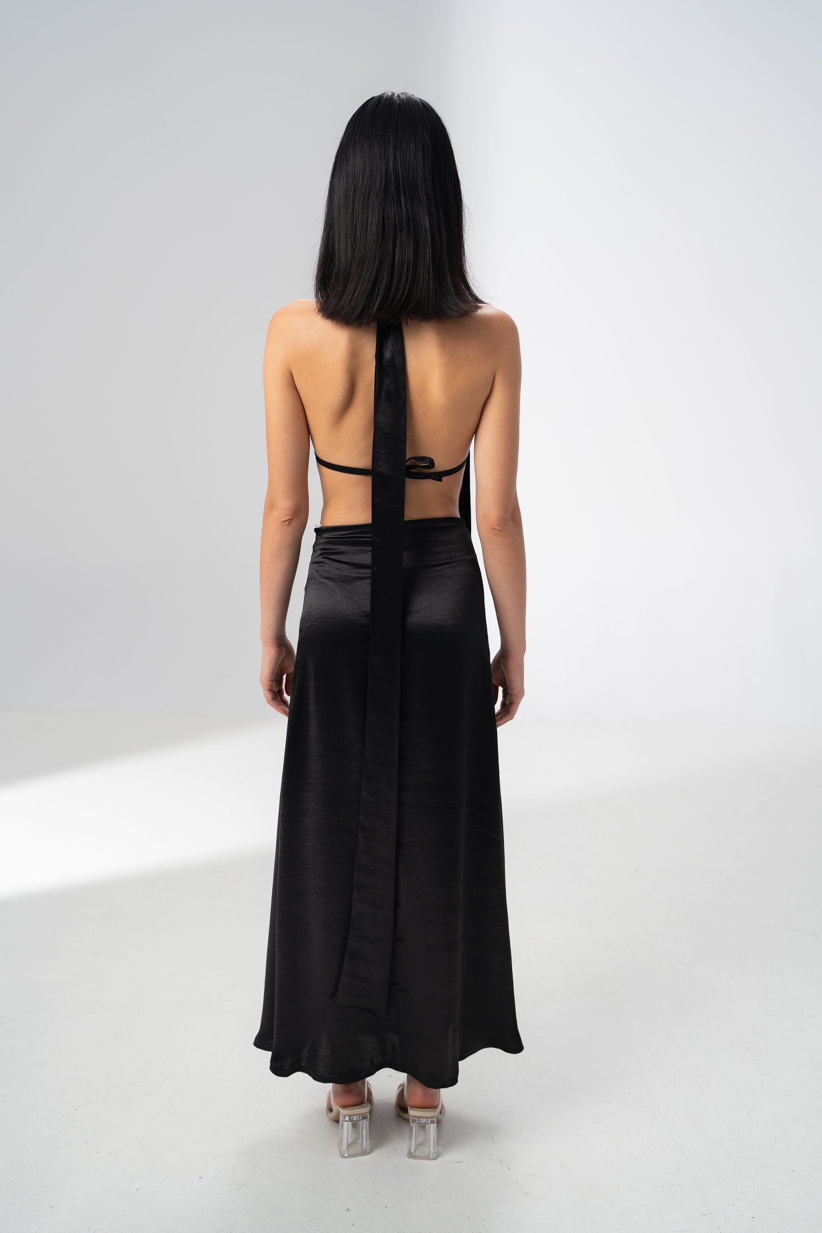 Draped bust and halter neck tie of the Girl Code black satin two piece set