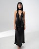 Model wearing the Girl Code black satin halter top and maxi skirt set with a deep V neckline