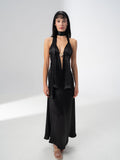 Model wearing the Girl Code black satin halter top and maxi skirt set with a deep V neckline