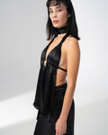 Open back of the black satin halter top tied with a long ribbon down the spine