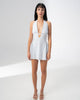 Model wearing the Girl Code blue polka dot halter dress with a deep plunging V neckline