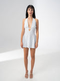 Model wearing the Girl Code blue polka dot halter dress with a deep plunging V neckline