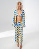 Model wearing the Girl Code blue and yellow satin three piece set with bralette, wide leg trousers and open shirt