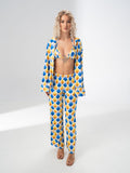 Model wearing the Girl Code blue and yellow satin three piece set with bralette, wide leg trousers and open shirt