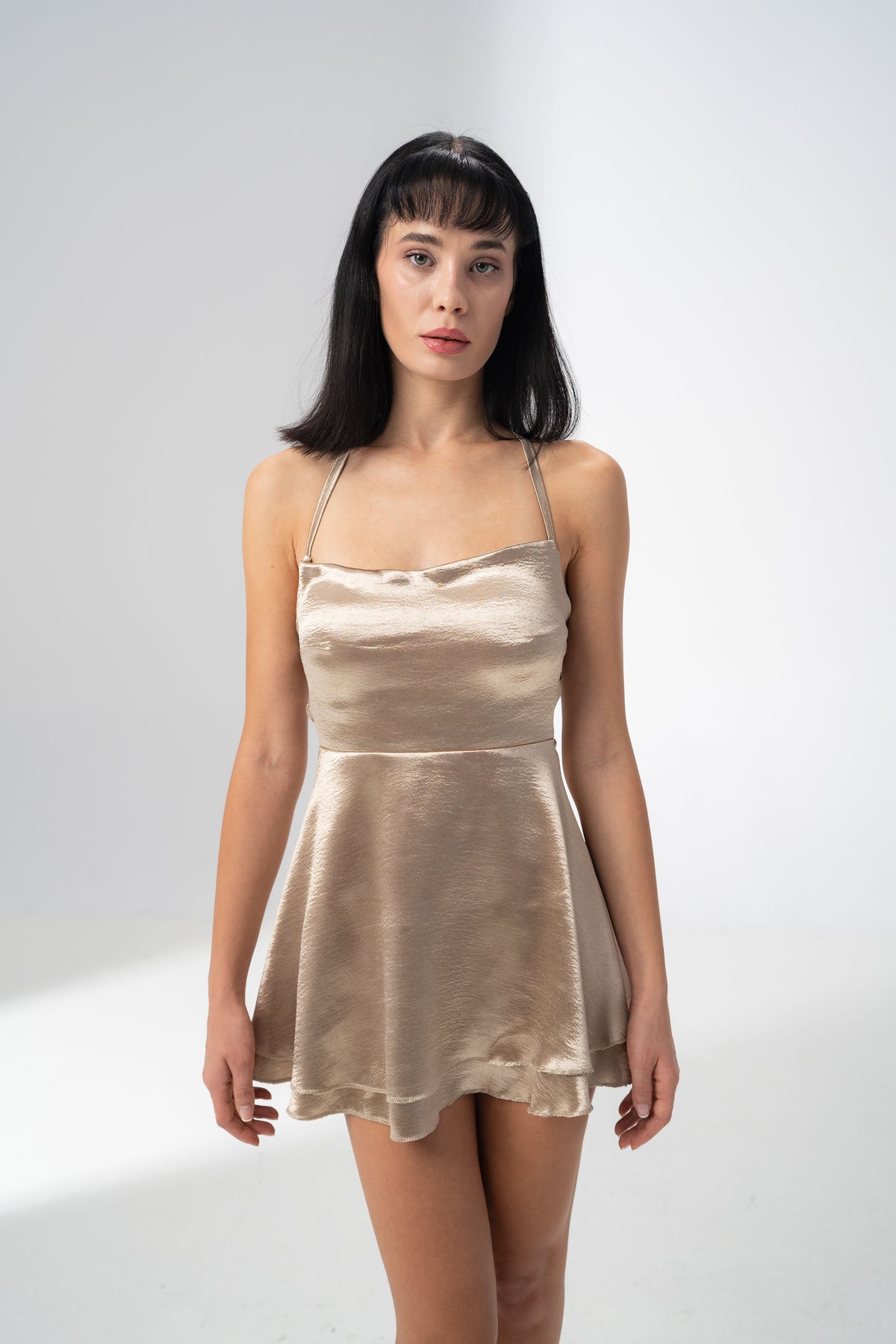 Girl Code champagne satin backless mini dress with a straight neckline