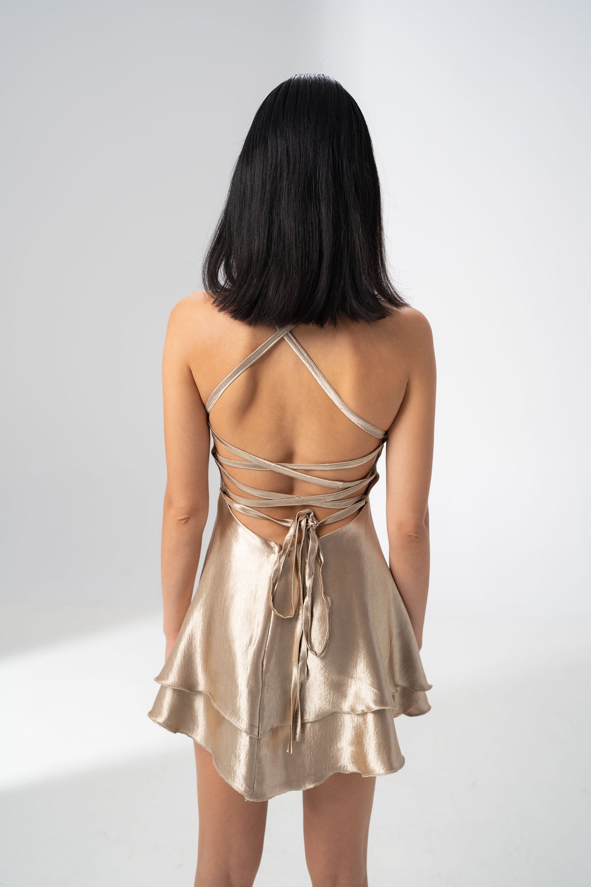 Girl Code champagne satin backless mini dress with crossed straps at the back
