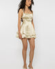 Model wearing Girl Code champagne satin strappy back mini dress, front view