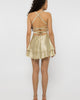Open back of the champagne satin mini dress with crossed straps and waist bow