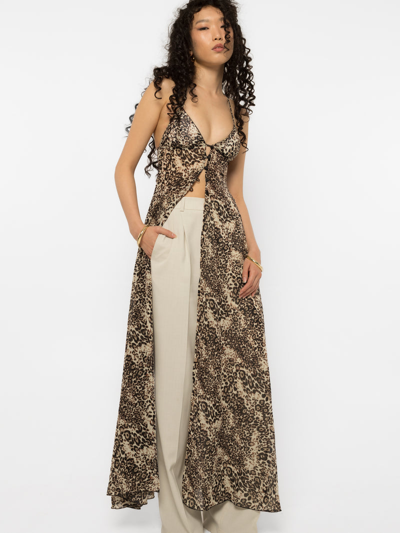 Model wearing Girl Code leopard print long shirt open over cream tailored trousers