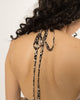 Self fabric halter ties knotted at the back neck of the leopard print long shirt