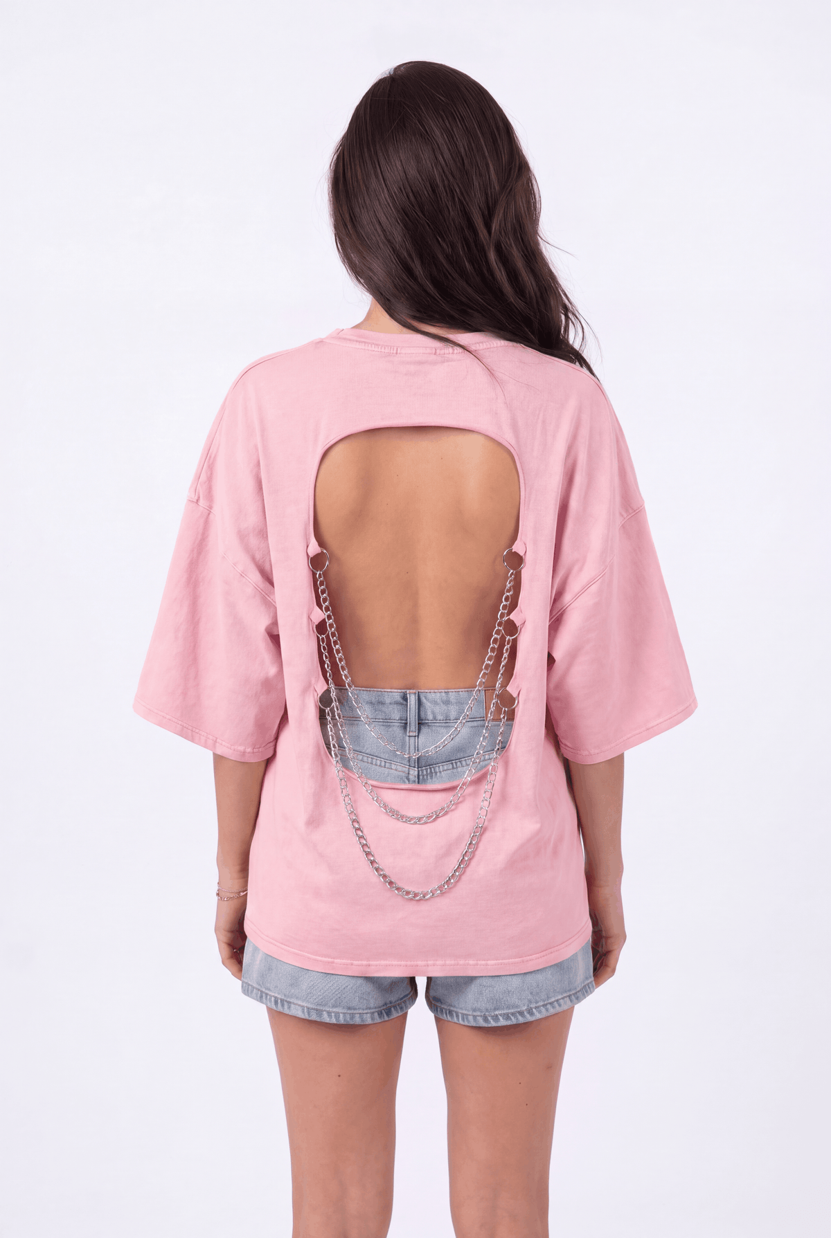Back view of the Girl Code pink chain back slogan t-shirt showing open back cutout with silver chains