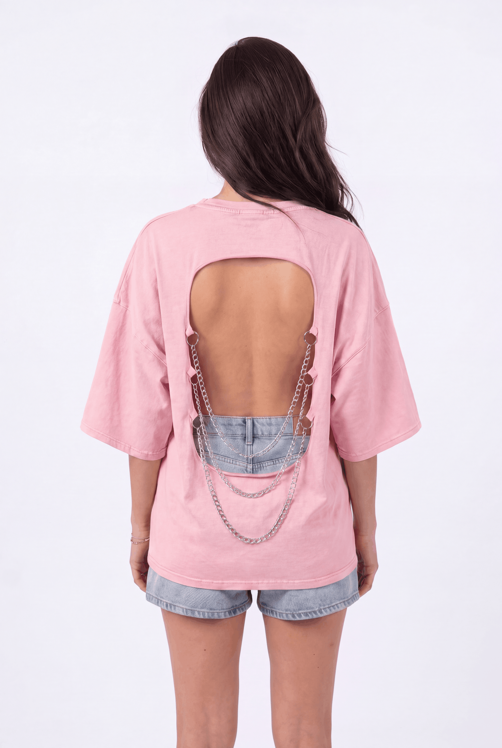 Back view of the Girl Code pink chain back slogan t-shirt showing open back cutout with silver chains