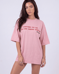 Model wearing Girl Code pink chain back slogan t-shirt, front view showing red printed text