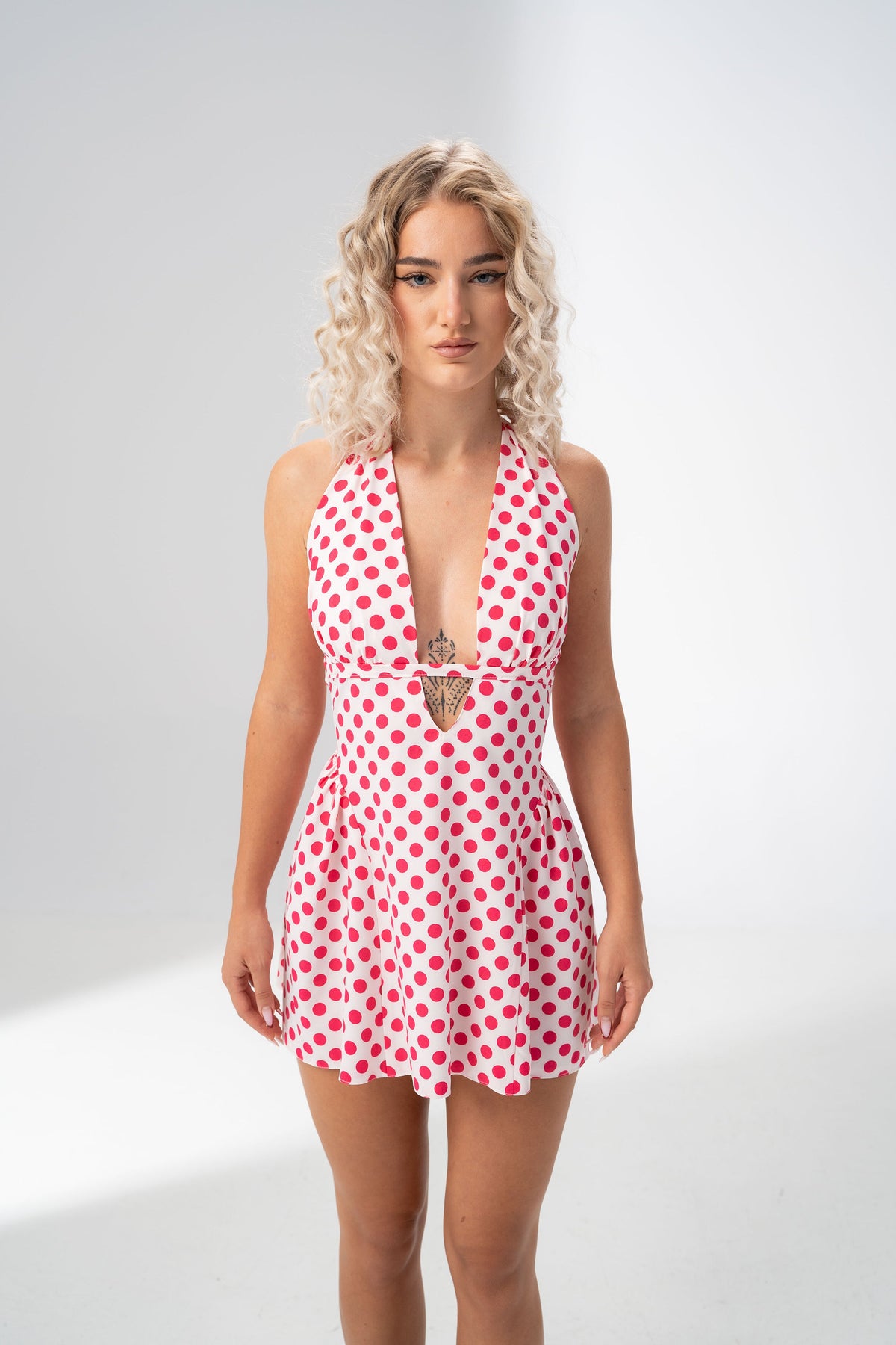 Girl Code polka dot halter mini dress showing the fitted bodice and cutout under the bust