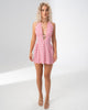 Model wearing the Girl Code polka dot halter mini dress with a deep plunging V neckline