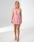 Model wearing the Girl Code polka dot halter mini dress with a deep plunging V neckline