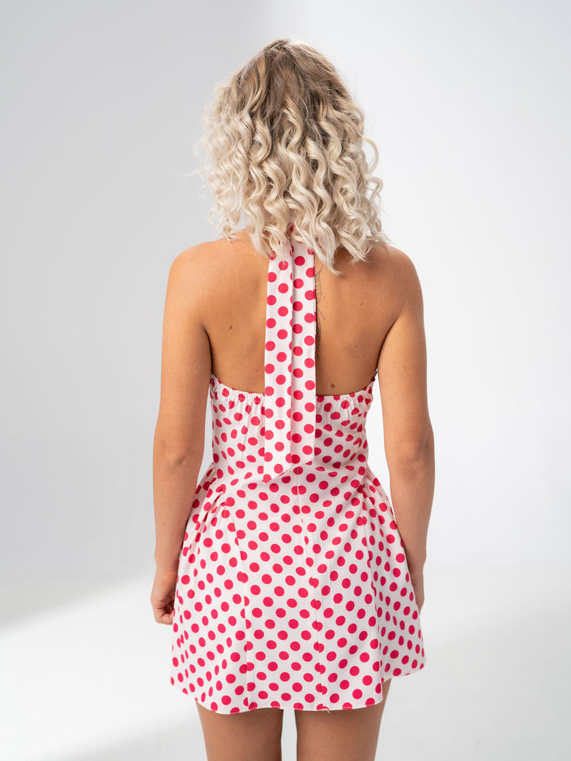 Open back and halter tie detail of the Girl Code polka dot halter mini dress