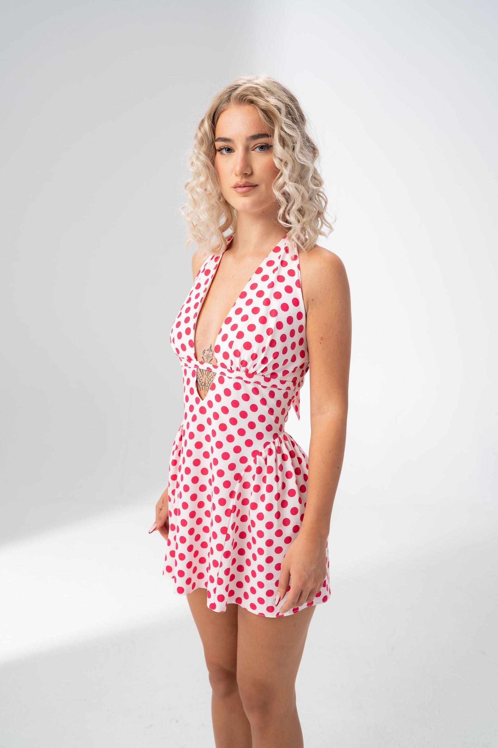 Girl Code polka dot halter mini dress worn with clear heels