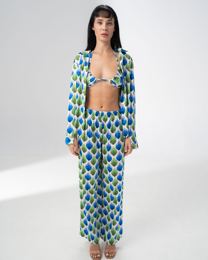 Model wearing the Girl Code printed satin three piece set with bralette, wide leg trousers and open shirt