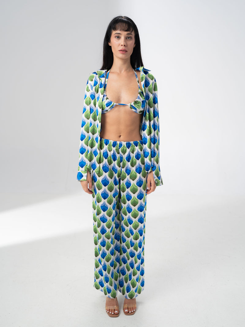 Model wearing the Girl Code printed satin three piece set with bralette, wide leg trousers and open shirt