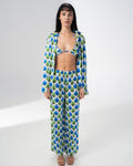 Model wearing the Girl Code printed satin three piece set with bralette, wide leg trousers and open shirt