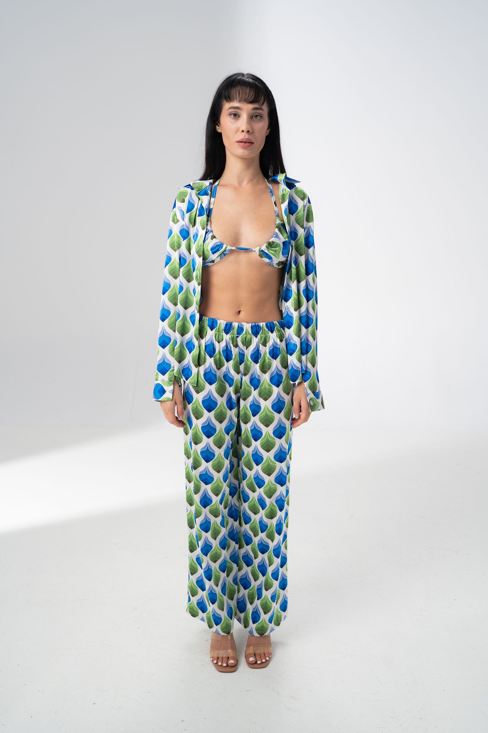 Model wearing the Girl Code printed satin three piece set with bralette, wide leg trousers and open shirt