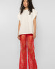 Model wearing Girl Code red lace-up palazzo pants, wide leg front view