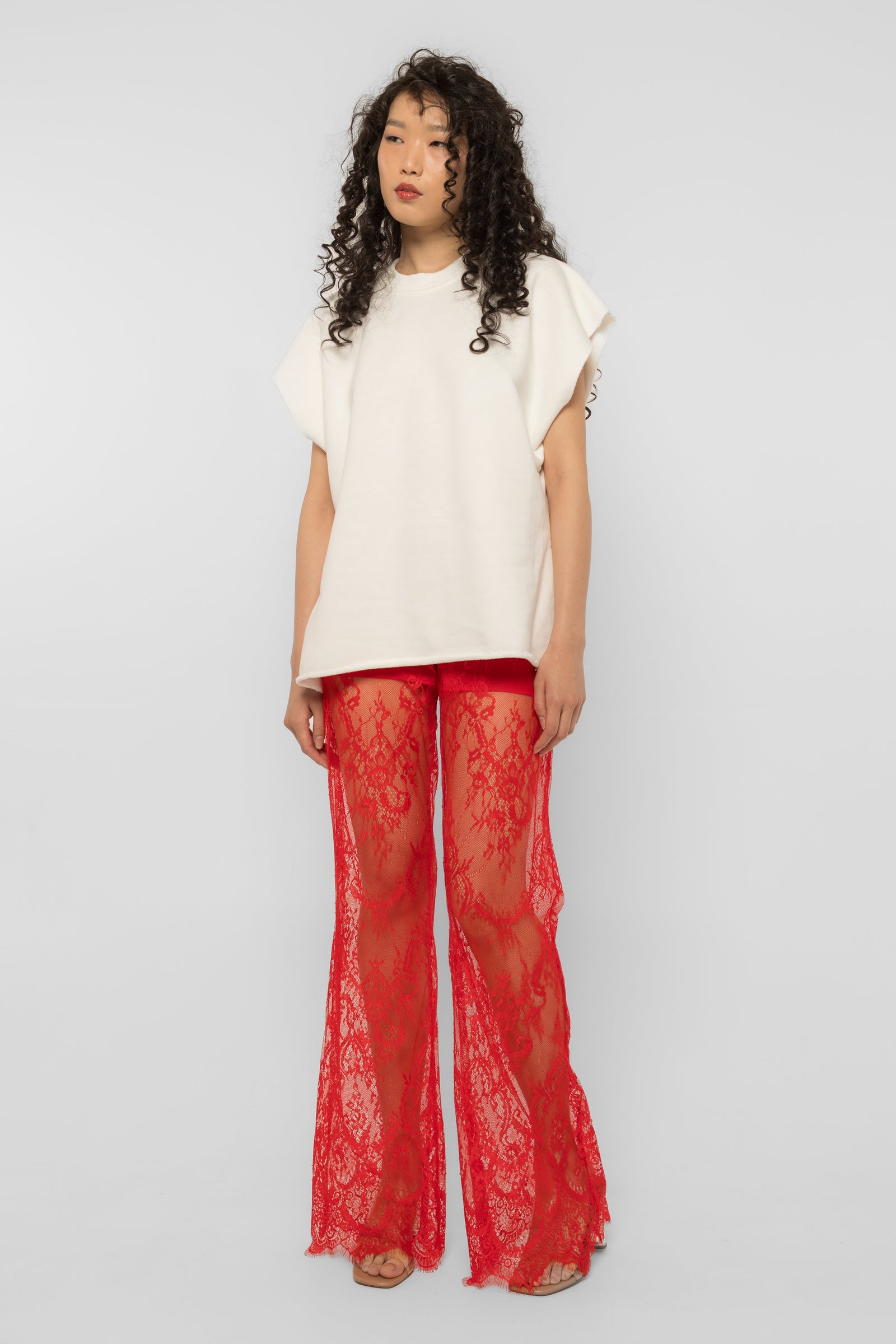 Model wearing Girl Code red lace-up palazzo pants, wide leg front view