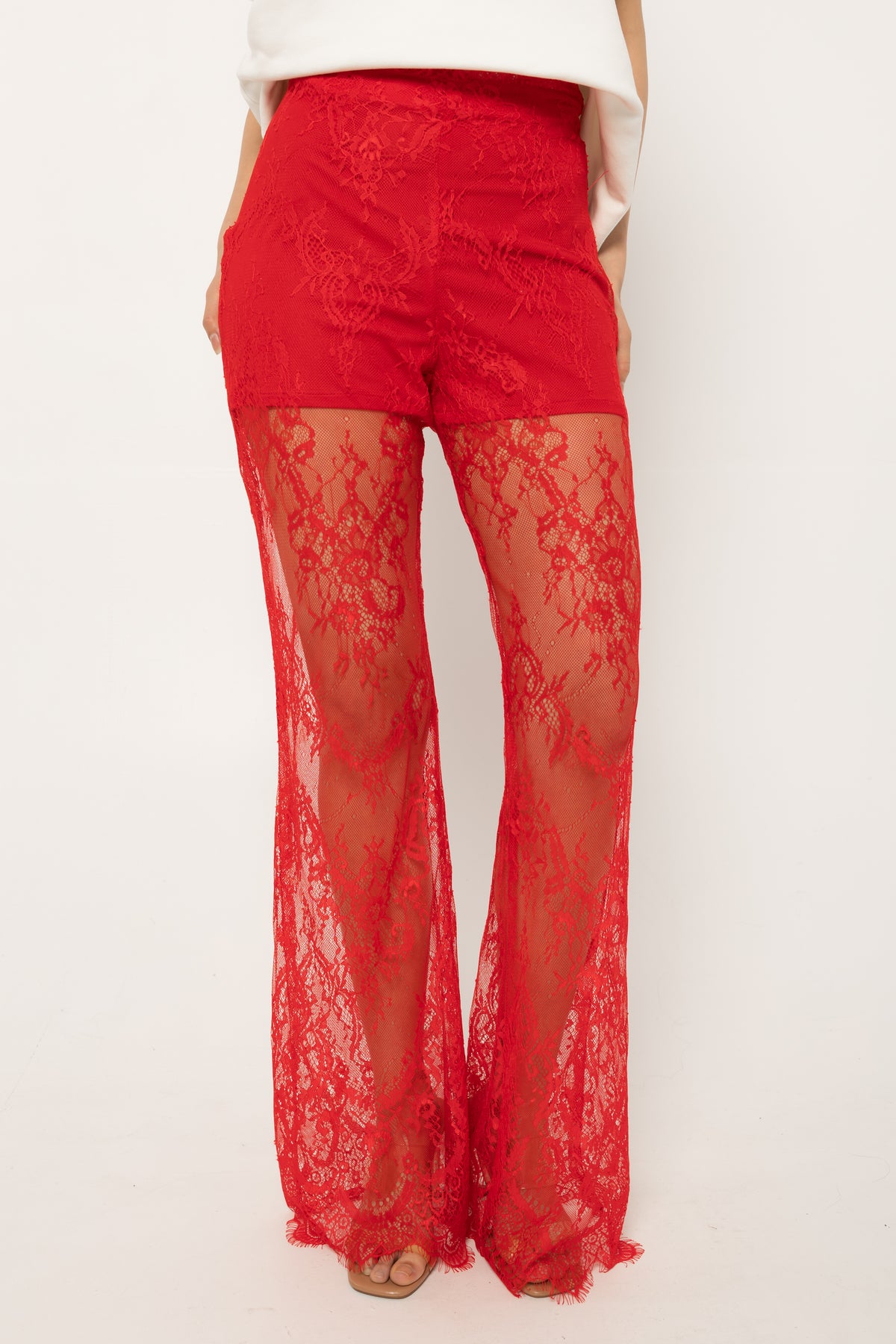 Lace-up detailing running down the leg of the red palazzo pants