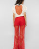 Side view of the Girl Code red lace-up palazzo pants showing the wide drape