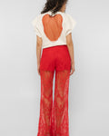 Side view of the Girl Code red lace-up palazzo pants showing the wide drape