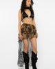Close up of the sheer snake print fabric and ruffle detail on the skirt
