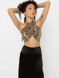 Model wearing Girl Code snake print wrap halter crop top with a black satin skirt