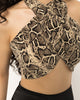 Snake print halter crop top with arms raised showing the open back and high neckline